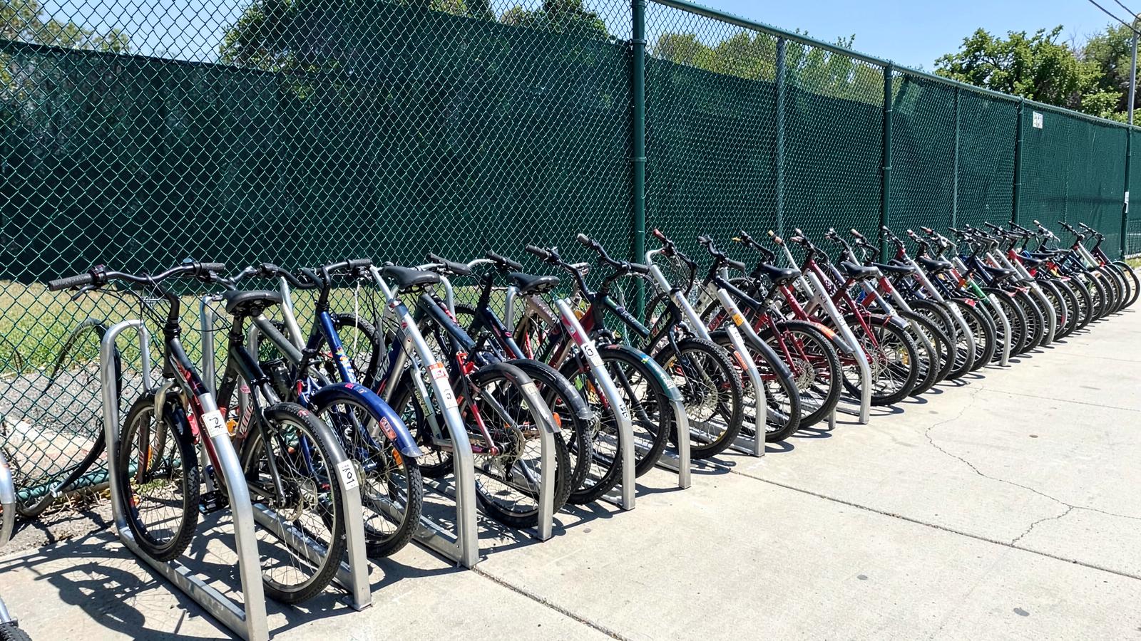 Student e-bikes neatly parked in numbered racks